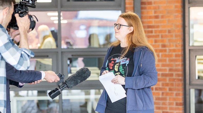 A-level success moment, results in hand, smiles on face, and straight into the TV spotlight!