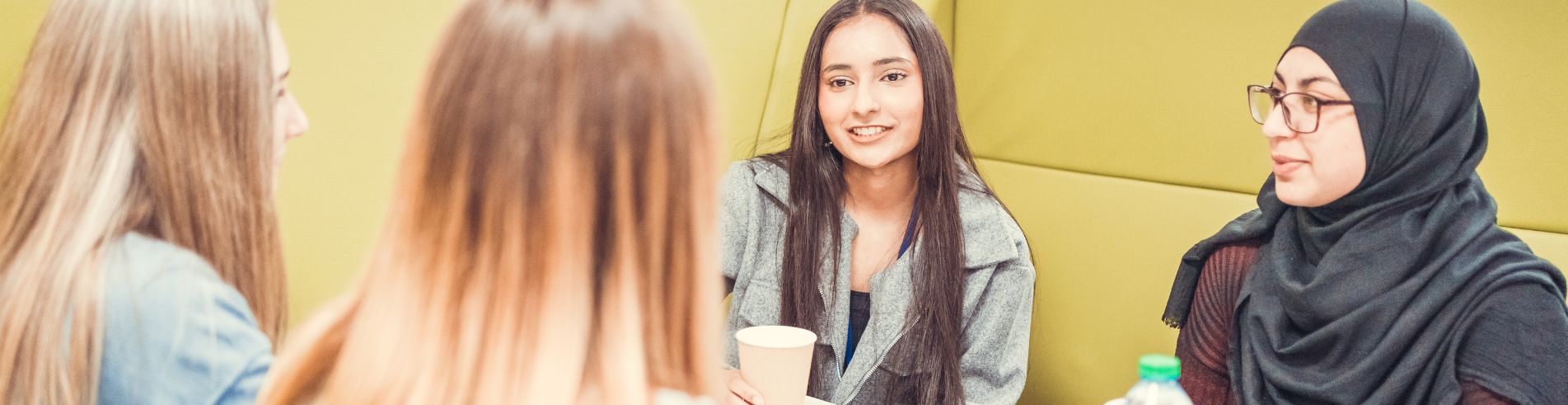 School policies page - group of sixth form students having coffee in the bistro